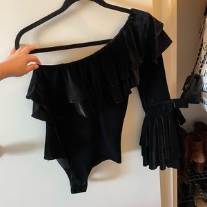 Velvet one shoulder bodysuit with snap closure.